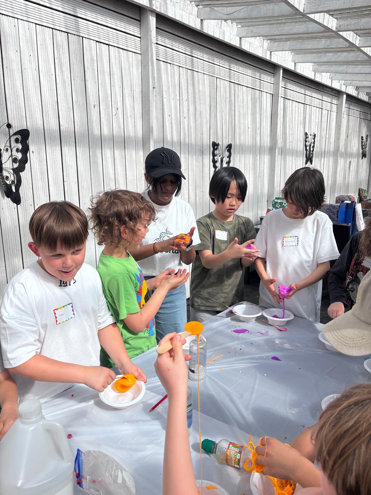 Children making colourful slime at a science birthday party