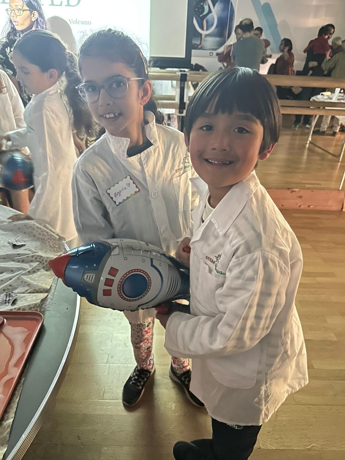 Children with a toy rocket at a science birthday party